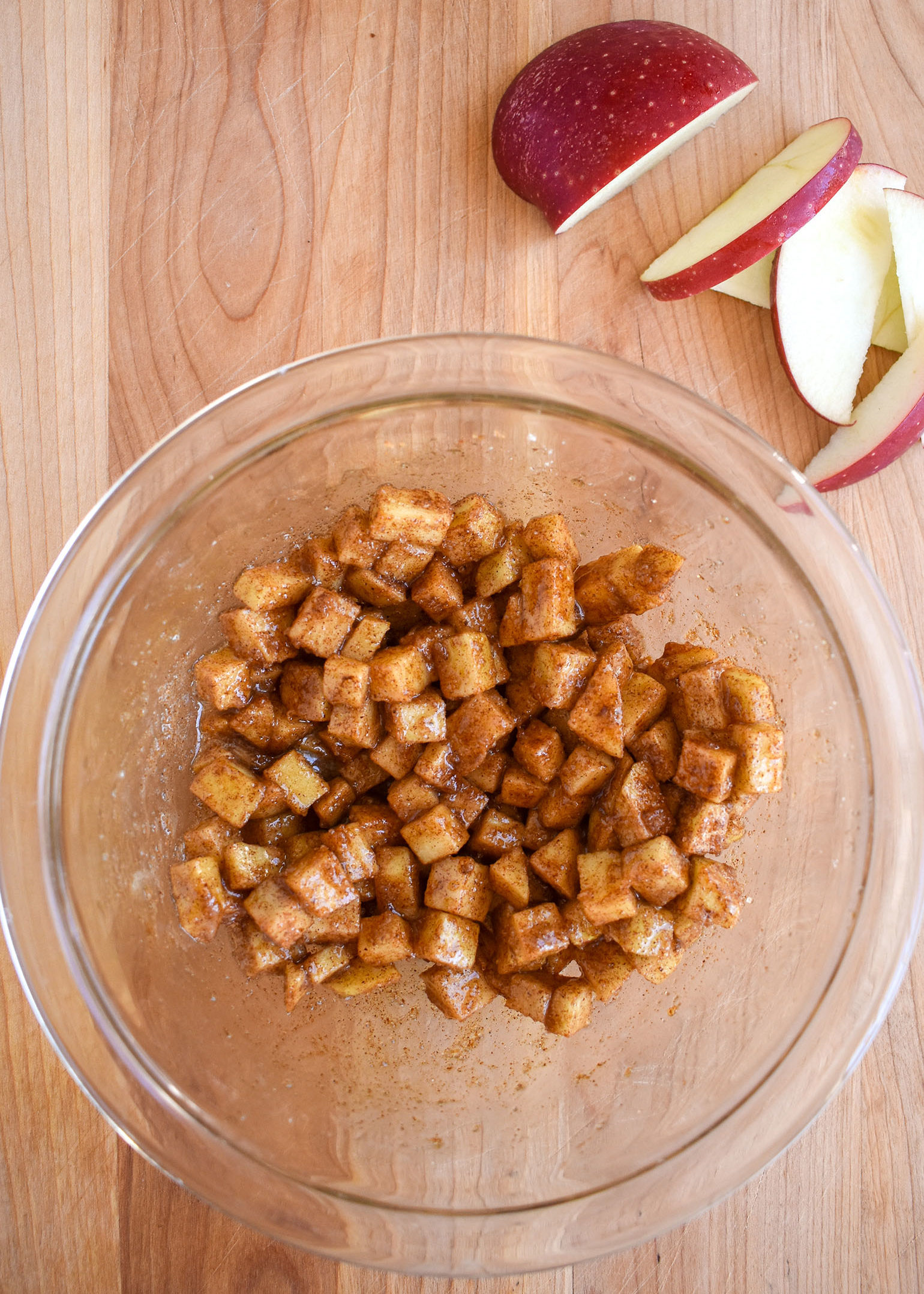 Baked apple cheddar hand pies -apples and spices mixed in a bowl